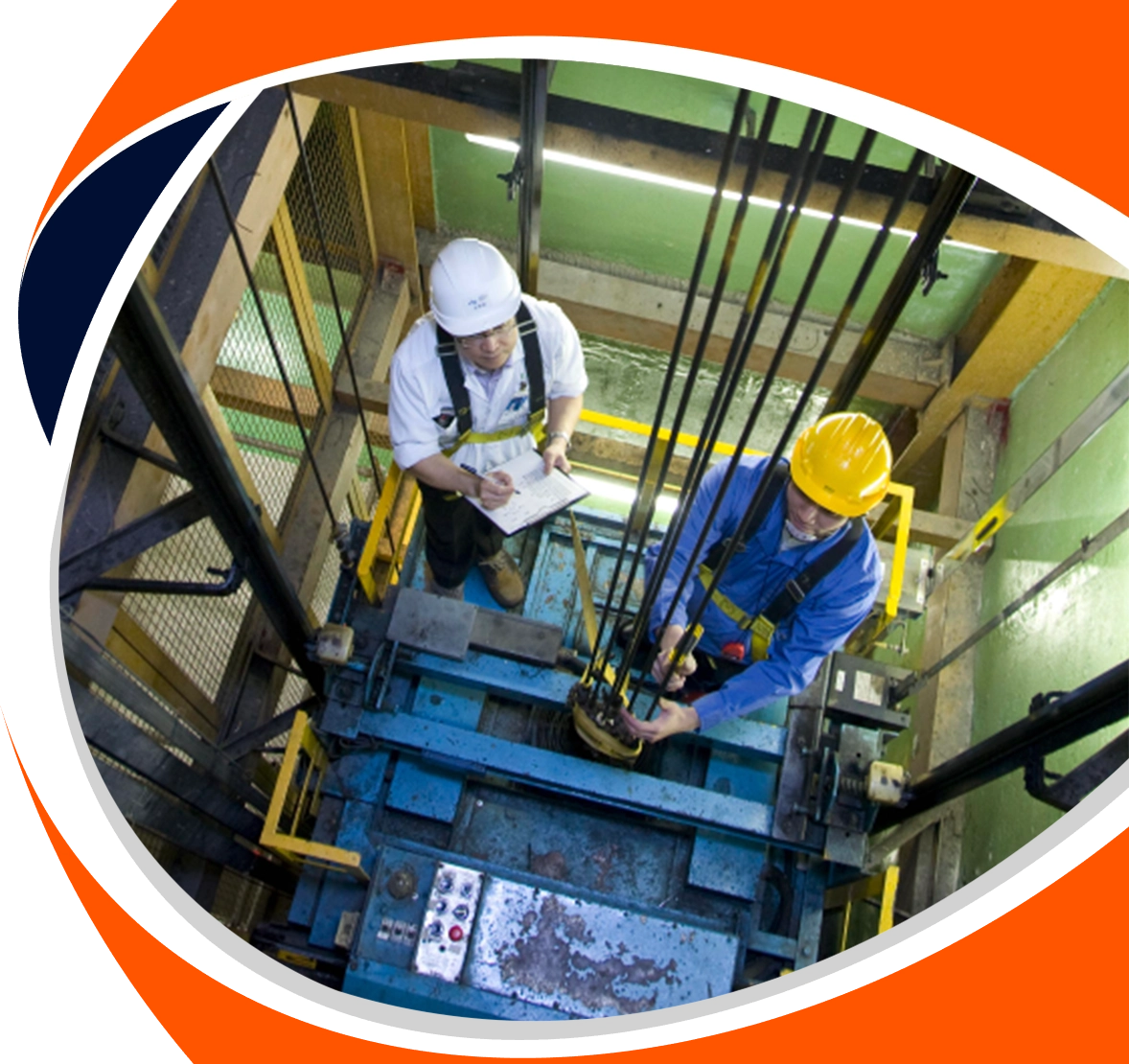 Home 5 http://Two%20technicians%20providing%20a%20thorough%20elevator%20service%20in%20Chennai,%20with%20one%20inspecting%20from%20a%20clipboard%20and%20the%20other%20working%20on%20the%20lift's%20mechanics%20from%20atop%20the%20car.